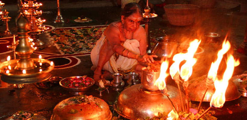 A women priest doing pooja on the occasion of Nag Panchami in Mannarasala Sree Nagaraja Temple near Haripad in the Alleppey district of Kerala.