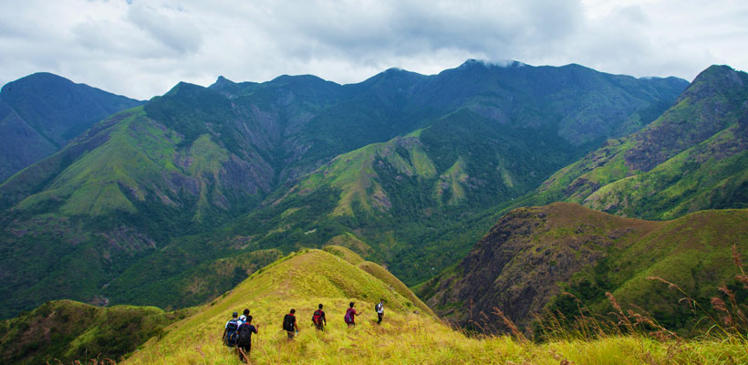 Young adventure enthusiasts trekking through the hills of Munnar
