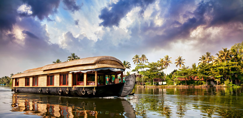 A houseboat sailing through the backwaters of Alleppey in Kerala.