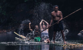 Tourists enjoying the bamboo rafting ride in the backwaters of Kerala