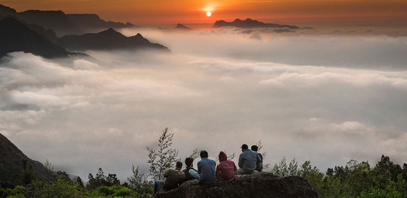 A scenic view of sunrise over the clouds from the Kolukkumalai sunrise view point in Munnar.